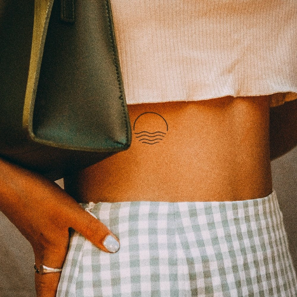 Tatouage océan coucher de soleil